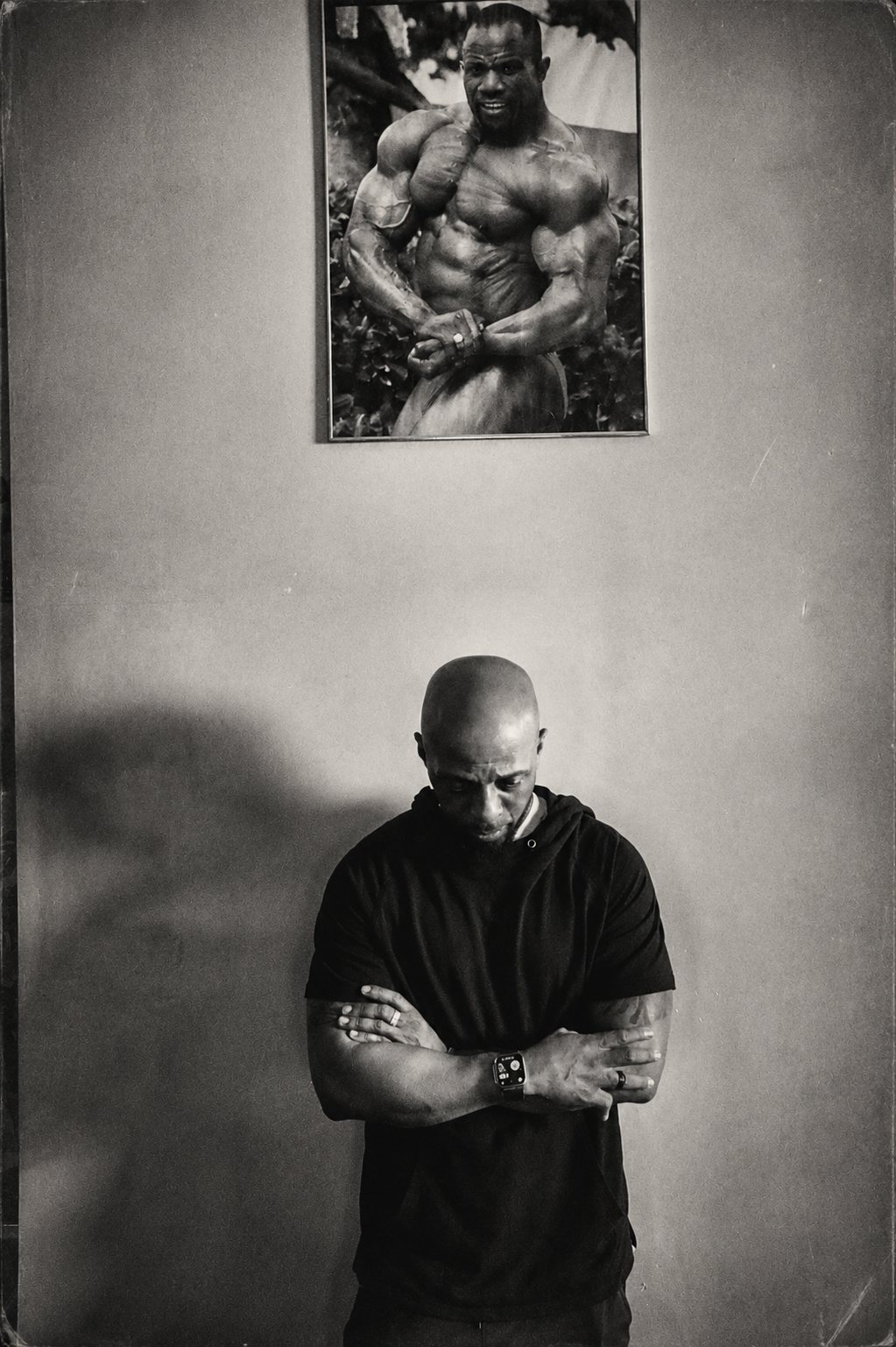 Jonathan Turmon standing beneath a portrait of his father, IFBB Pro George Turmon